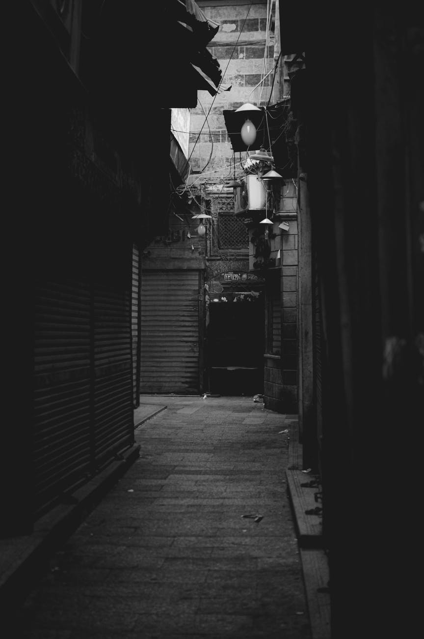 monochrome photograph of an alley with closed stores